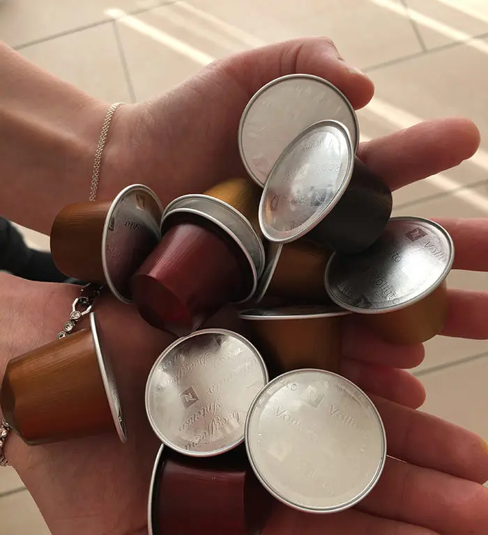 coffee capsules in hands