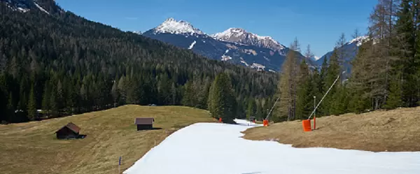 Artificial snow in the green mountains.