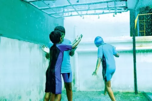 Autistic children enjoying a shower of rain in their leisure time.