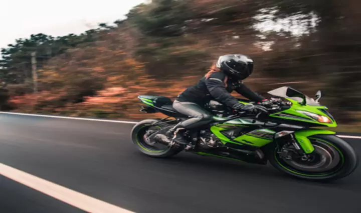 female-driver-driving-green-neon-color-motorcycle-road