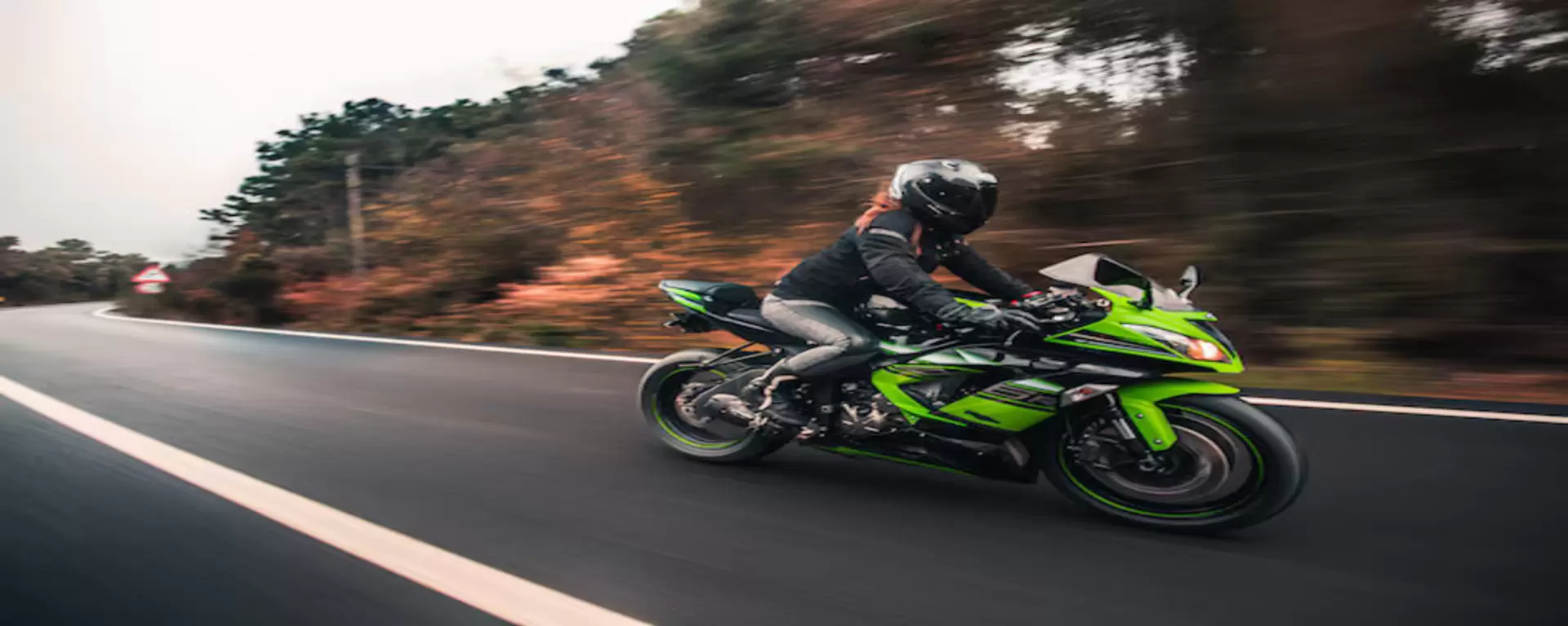 female-driver-driving-green-neon-color-motorcycle-road