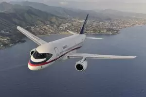 Air-to-air photo of a Sukhoi Superjet 100 (97004) over Italy